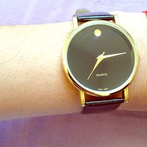 Black strapped gold rim watch