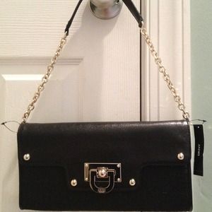 Brand new DKNY clutch with gold detailing.