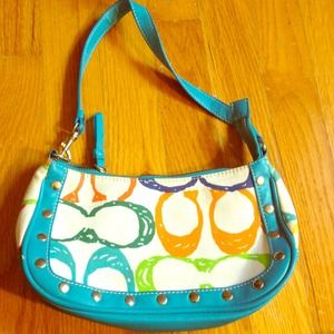 Blue, orange, green, and white coach purse.