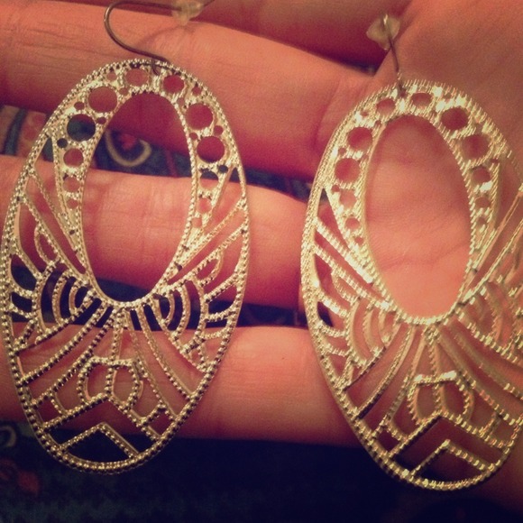 Silver tone dangle earrings.