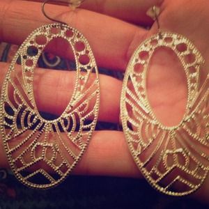 Silver tone dangle earrings.