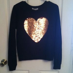 Sweater with sequenced heart.