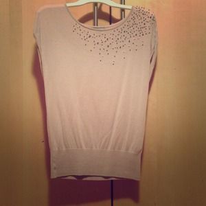 Cute beige top with beads on one shoulder.