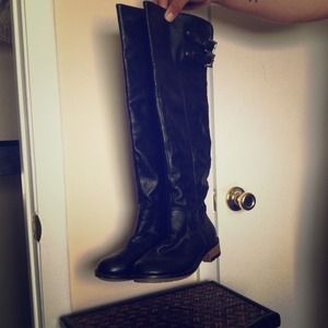 HOLD Black knee high riding boots w buckle detail.