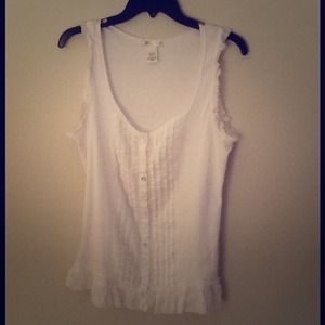 White sleeveless button up.