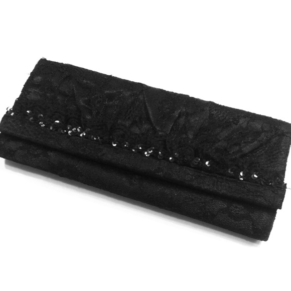 **Sold**Lacy black clutch