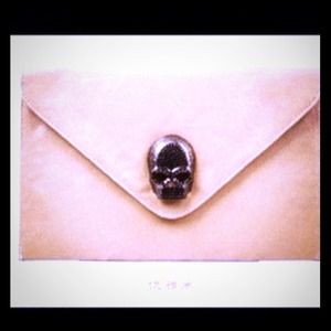 beige skull clutch