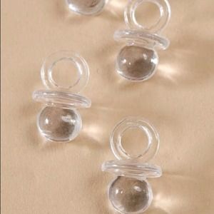 Clear 0.75" baby shower pacifier favors.