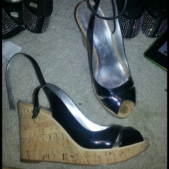 Black patent leather wedges by Guess