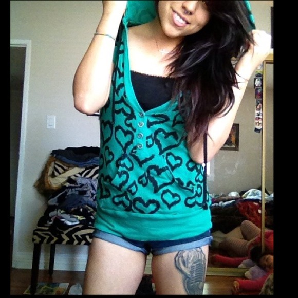 Green hooded shirt with heart pattern.