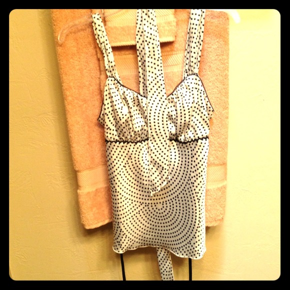 An off white silky blouse with black polkadots