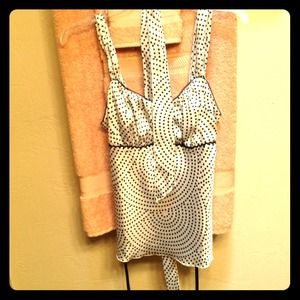 An off white silky blouse with black polkadots