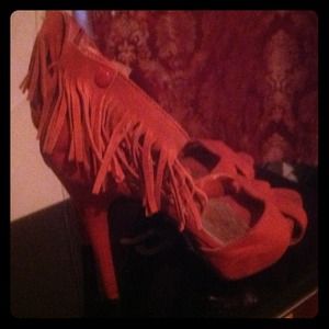 Orange suede heels with tassel ankle.
