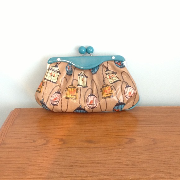 Fossil birdcage coated canvas clutch.