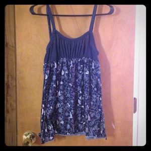 Spaghetti strap blue shirt with floral design.
