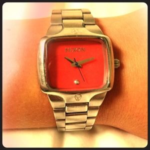 Silver and pink Nixon watch