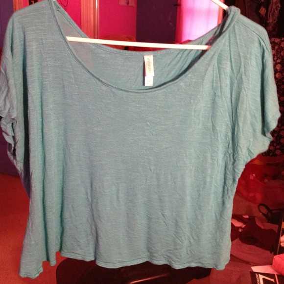 Bright teal half length shirt, that splits in back