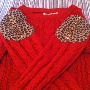 Red sweater with leopard spike detail
