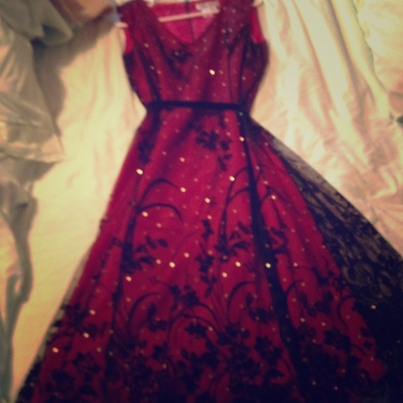 Red, gold, black lace mid-length party dress.