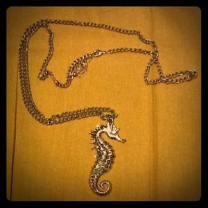 Cute long gold colored Seahorse Necklace.