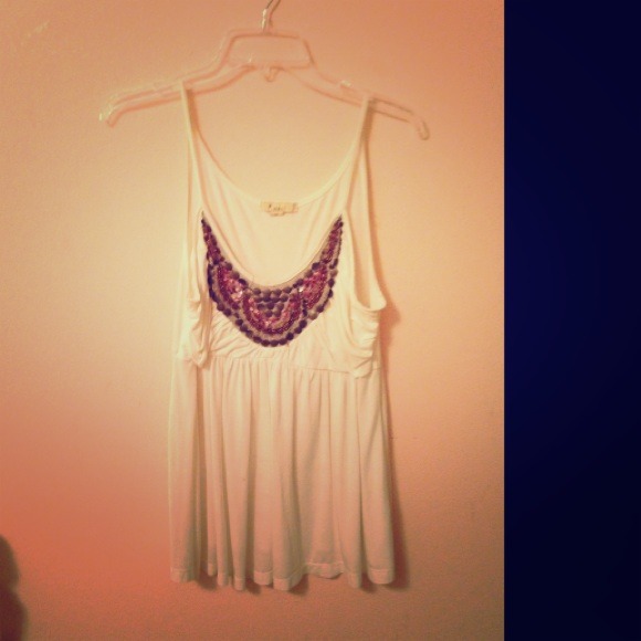 White shirt with beads on it