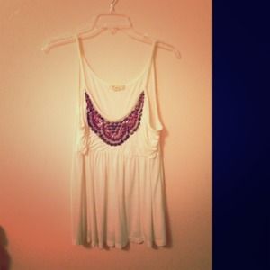 White shirt with beads on it