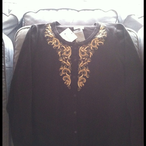 Black sweater with gold embroidery.