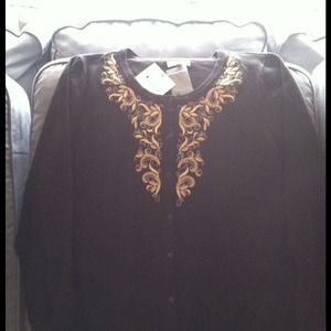 Black sweater with gold embroidery.