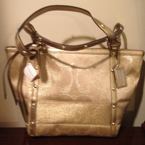 Brand new with tags  coach  handbag in gold.