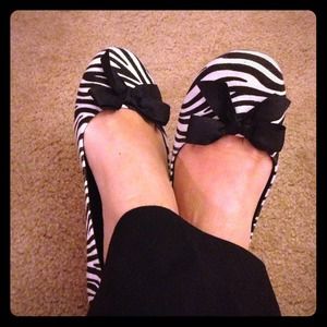 Zebra print flats with black bow on the front