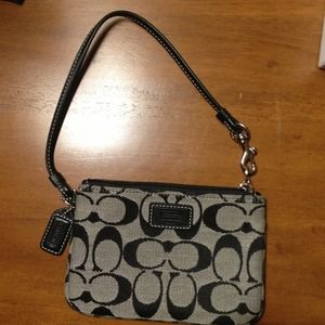 SOLD. Authentic Coach wristlet in black signature.