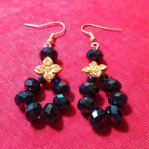 Navy blue earrings with gold flower.