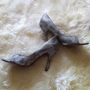 Silver snakeskin pumps.