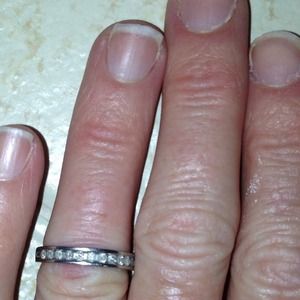 10k white gold band with round diamonds.