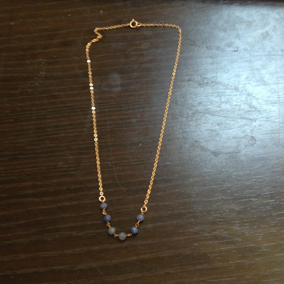 Delicate gold chain with blue beads.