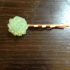 Hair pin with light blue flower.