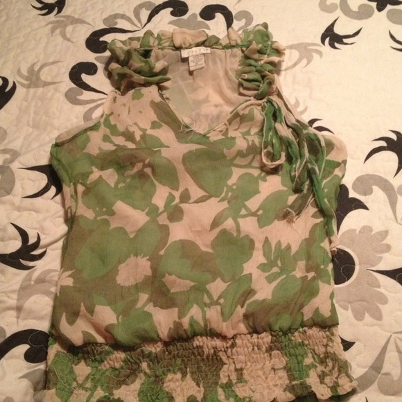 Tab and green sleeveless floral blouse