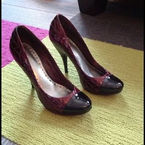 Maroon and black patent pumps.