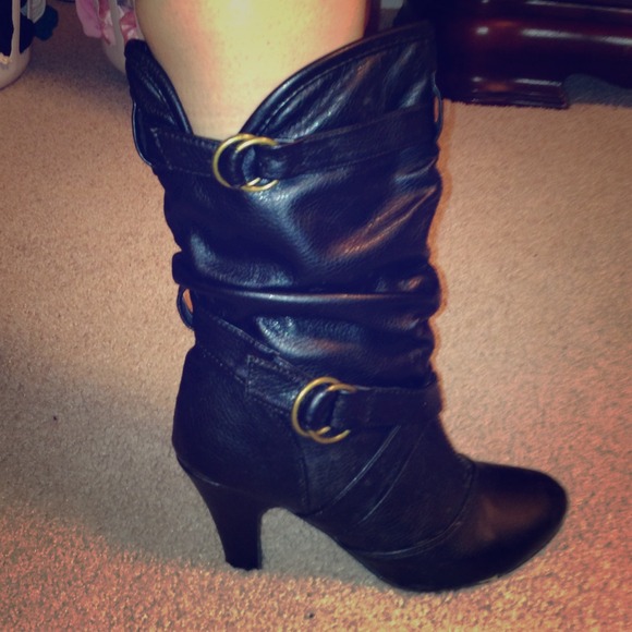 Black calf boots with gold buckles.
