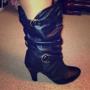 Black calf boots with gold buckles.