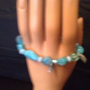 Turquoise color shells looking beaded bracelet .