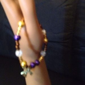 Colt tone bracelet with charm