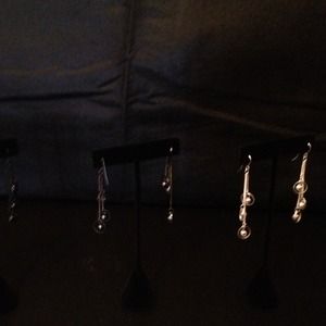 silver dangle earrings and black dangle earring