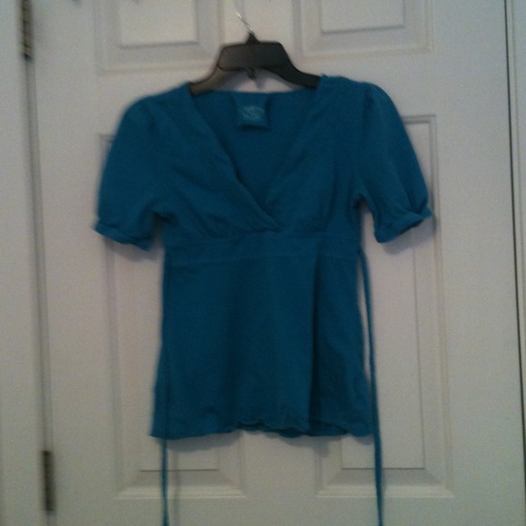 Turquoise shirt , short sleeve , ties in back