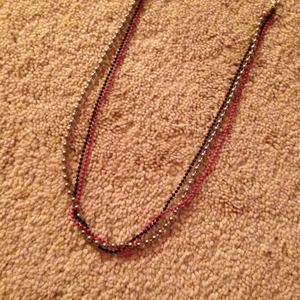 Black, pink, and silver chain necklace.