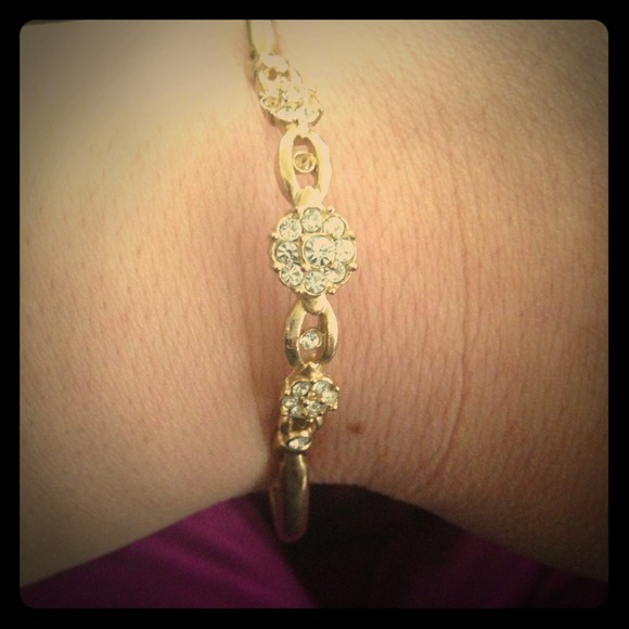 Gold tone bracelet. With rhinestones.
