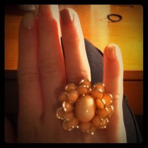 Salmon-colored cocktail gold ring