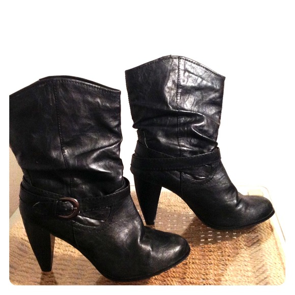 High heeled black leather-like boots.