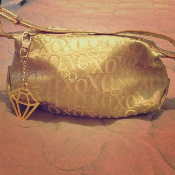 XOXO gold handbag.