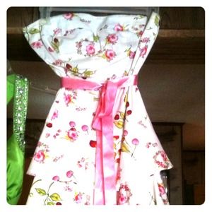 White dress with a pink bust band.